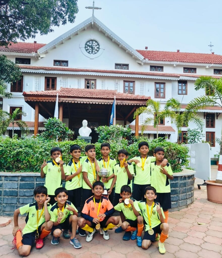 U10 DaSilva Boys at School Entrance with Trophy