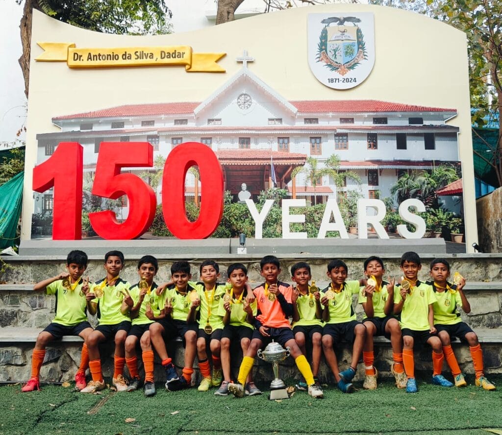 U10 Boys With Trophy in School in Front of 150 Years